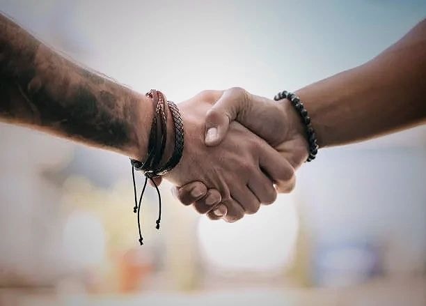 Two people shaking hands symbolizing trust and partnership